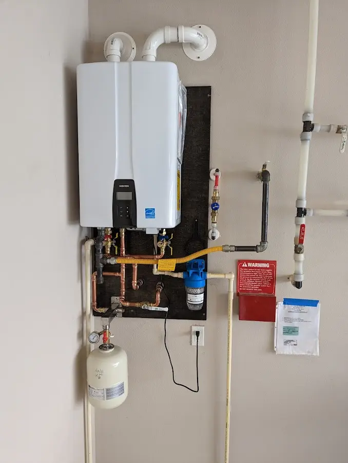 Professional plumber installing copper piping in a Virginia home